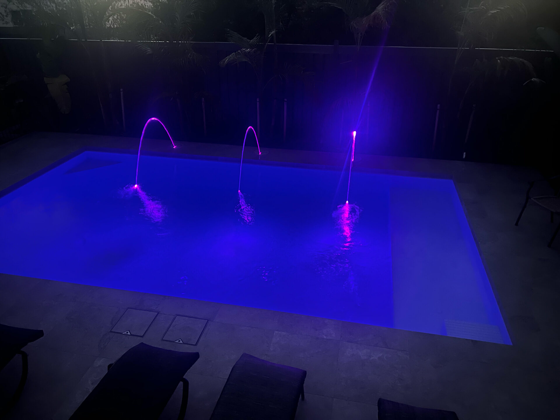 Plenty swimming pool at night with lights project by Venetian Pools